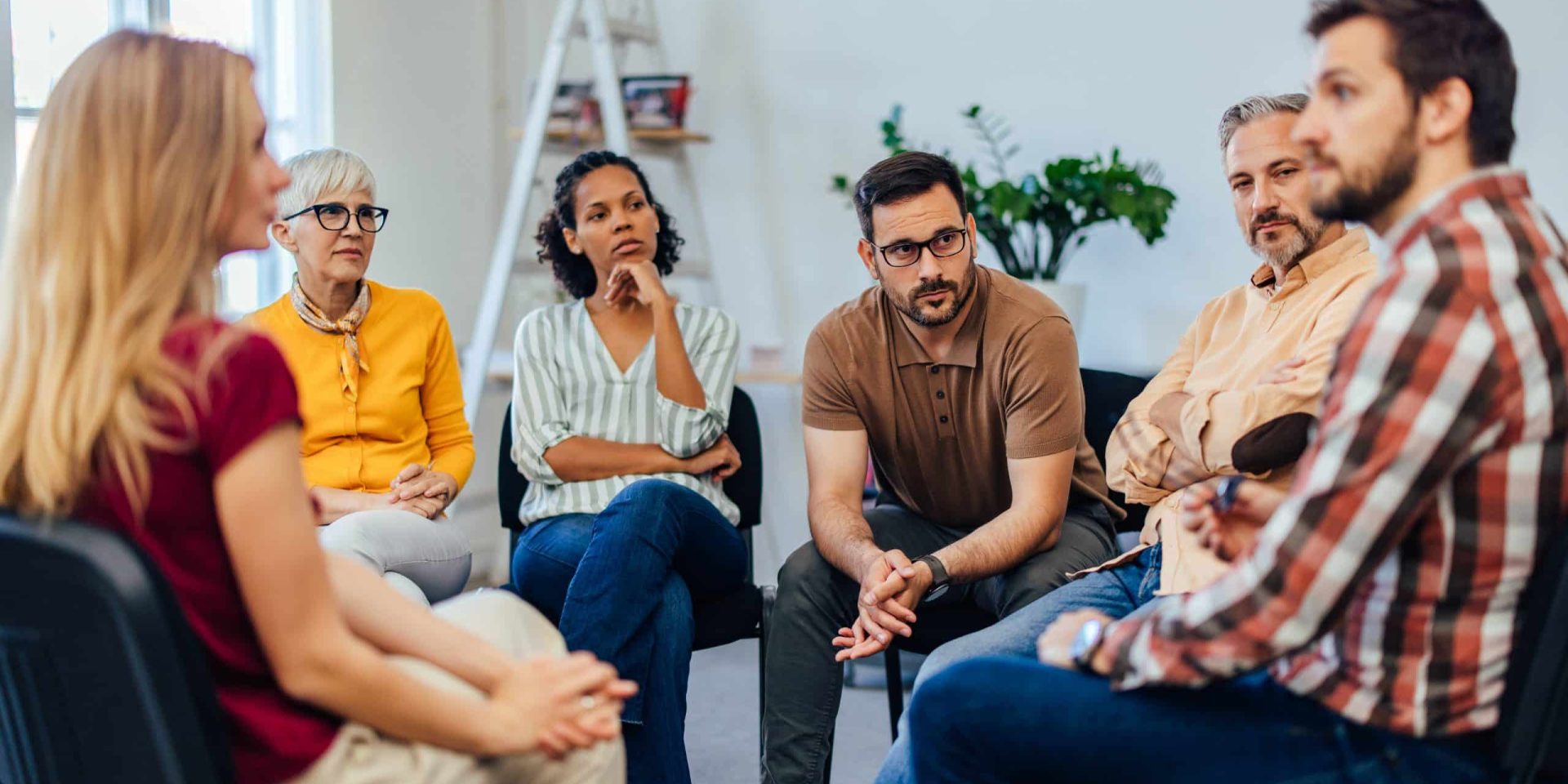 Support group sitting in a circle discussing recovery, representing the range of addictions treated at rehab centres in Cape Town